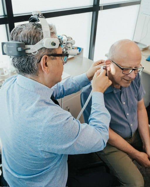 Dr. Amir Soltani working with a patient at North Vancouver Hearing Aid