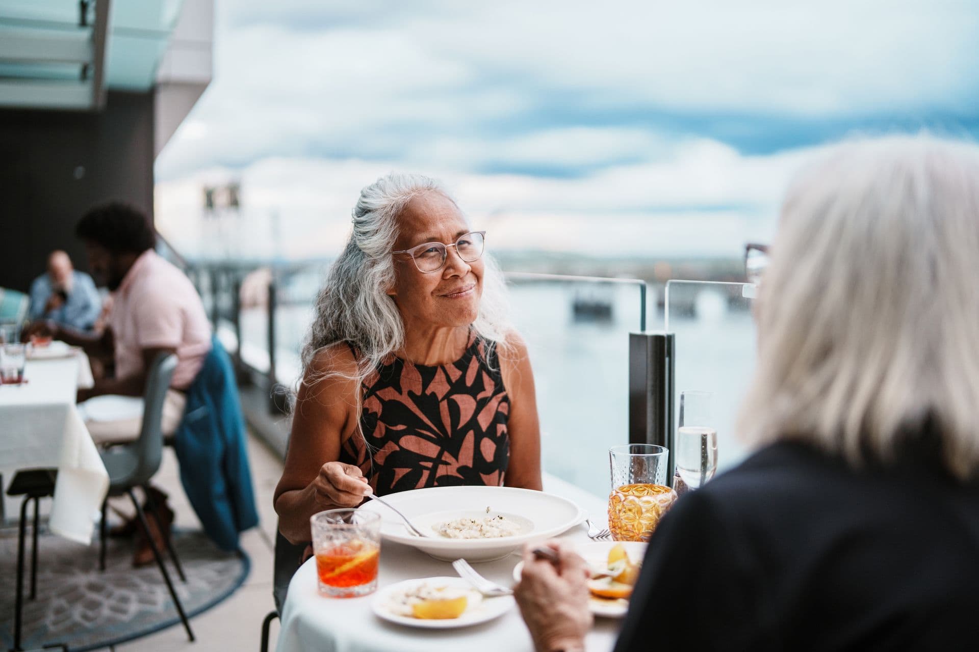 Woman enjoying a conversation with a friend over dinner in North Vancouver